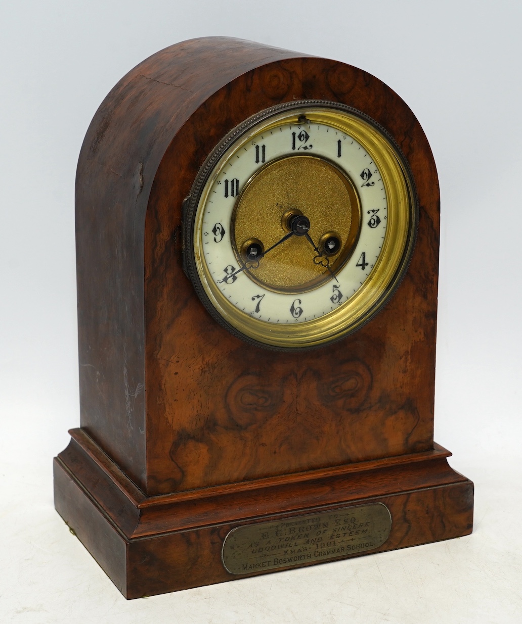 An Edwardian mantel clock with Arabic dial and applied plaque, 25cm high. Condition - fair to good, some cracking to the wood